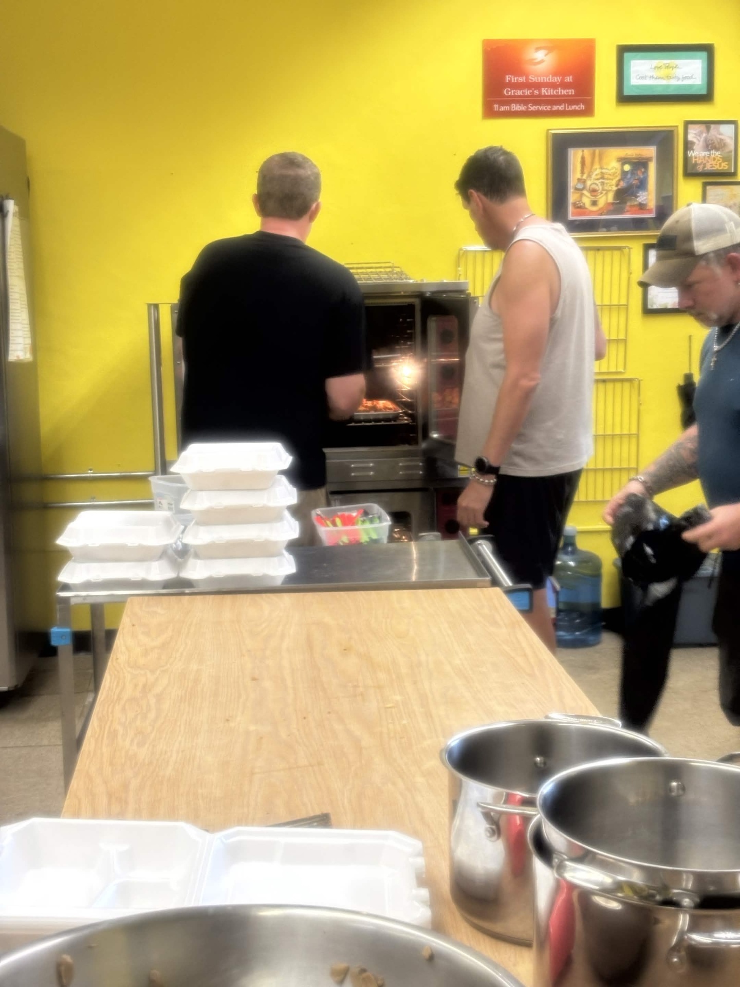 Volunteers working in the kitchen during Team Mess Hall at Gracie's Kitchen.
