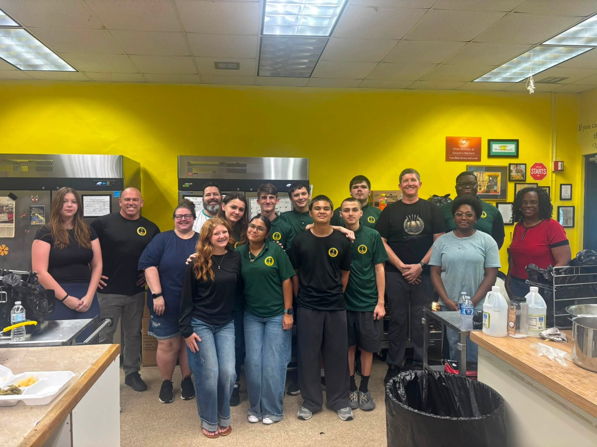 Team Mess Hall volunteers and community partners gathered together in the kitchen at Gracie's Kitchen on August 28, 2026.