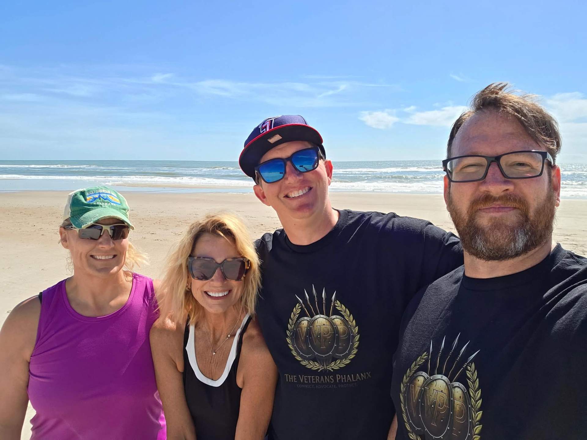 Veterans and community members gathered on the beach for the United on The Sand community yoga event.